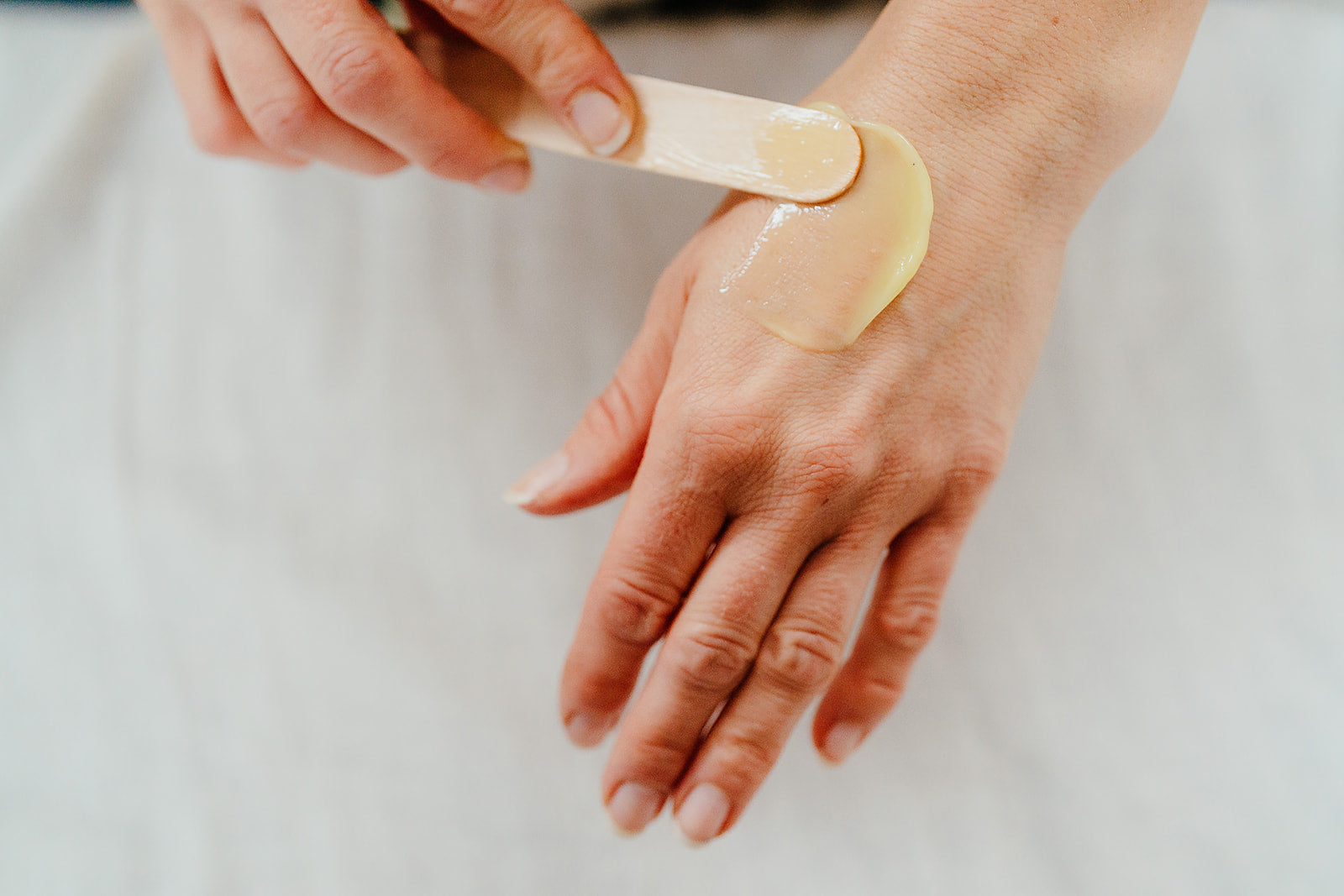 An image to show our Calm and Cleanse balm spread on a hand. Creamy, balmy consistency. Plant based beauty. Vegan skincare. Vegan beauty. Salt & Clay. Hampshire. 