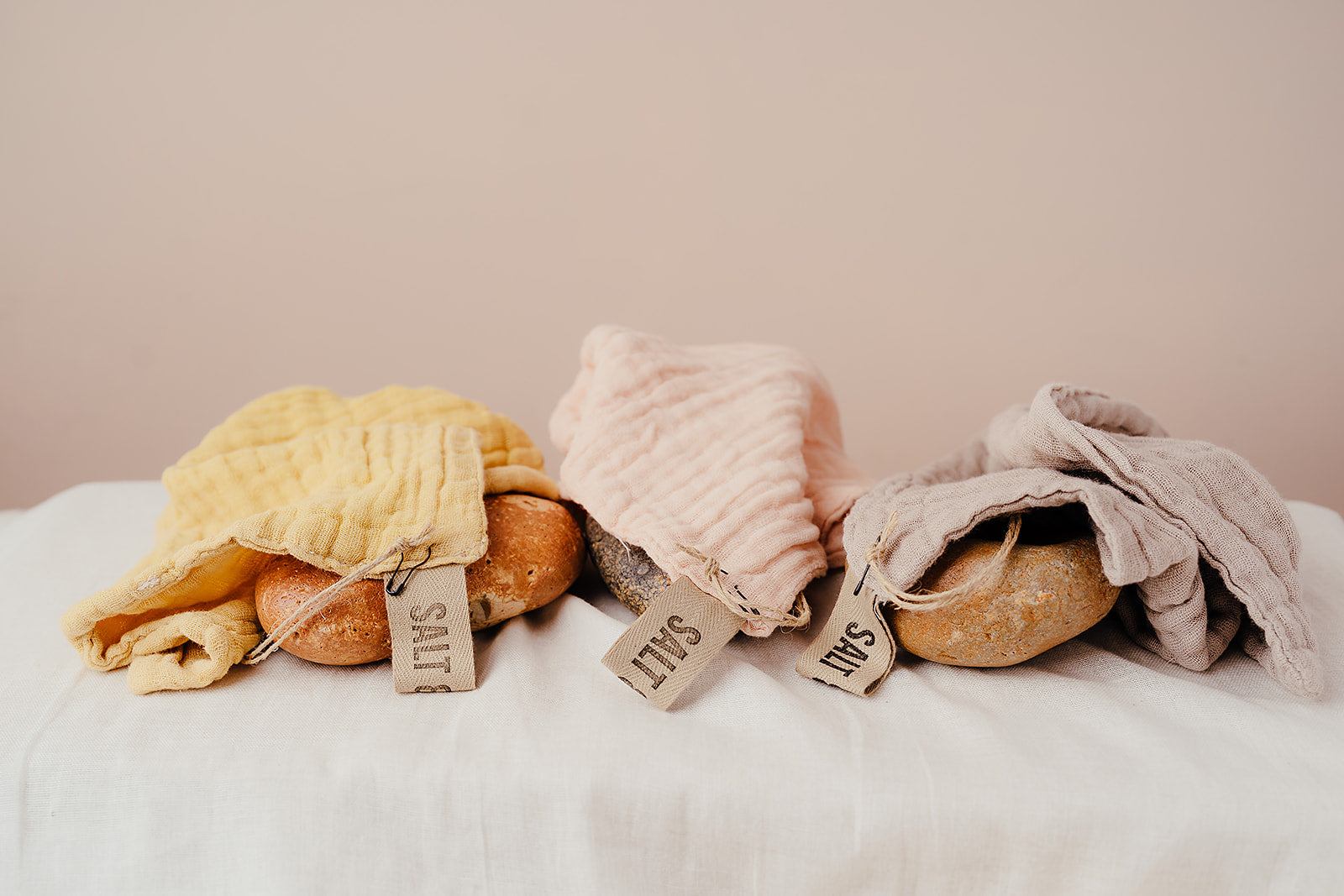 Image of three face cloths. Turmeric tea, Avocado and Avocado and Iron water. Face cloth. Hand dyed with natural fruit and vegetable dyes. Vegan skincare. Salt & Clay. Hampshire UK.